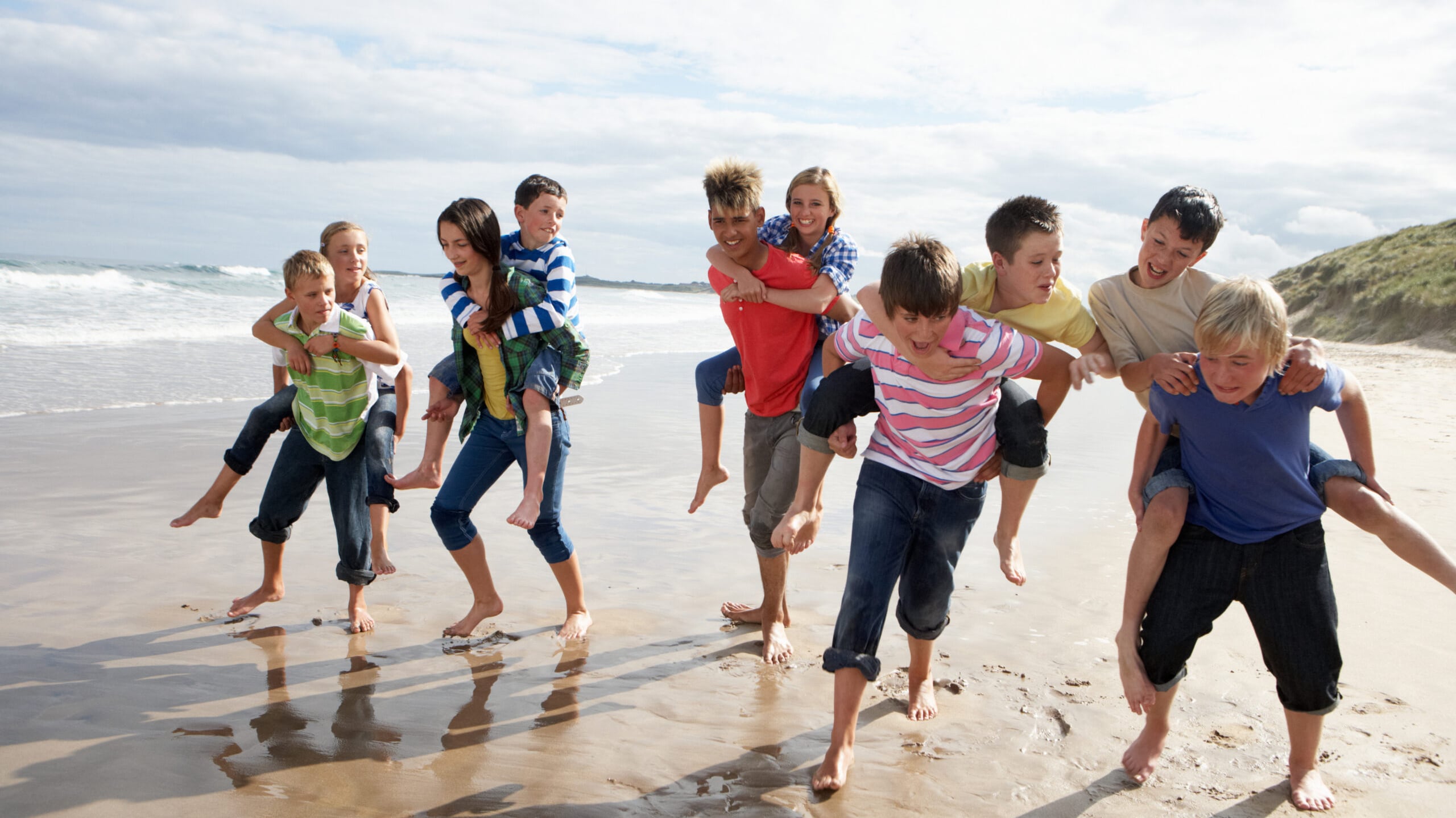 Tweens and teens on a beach in the spring time.